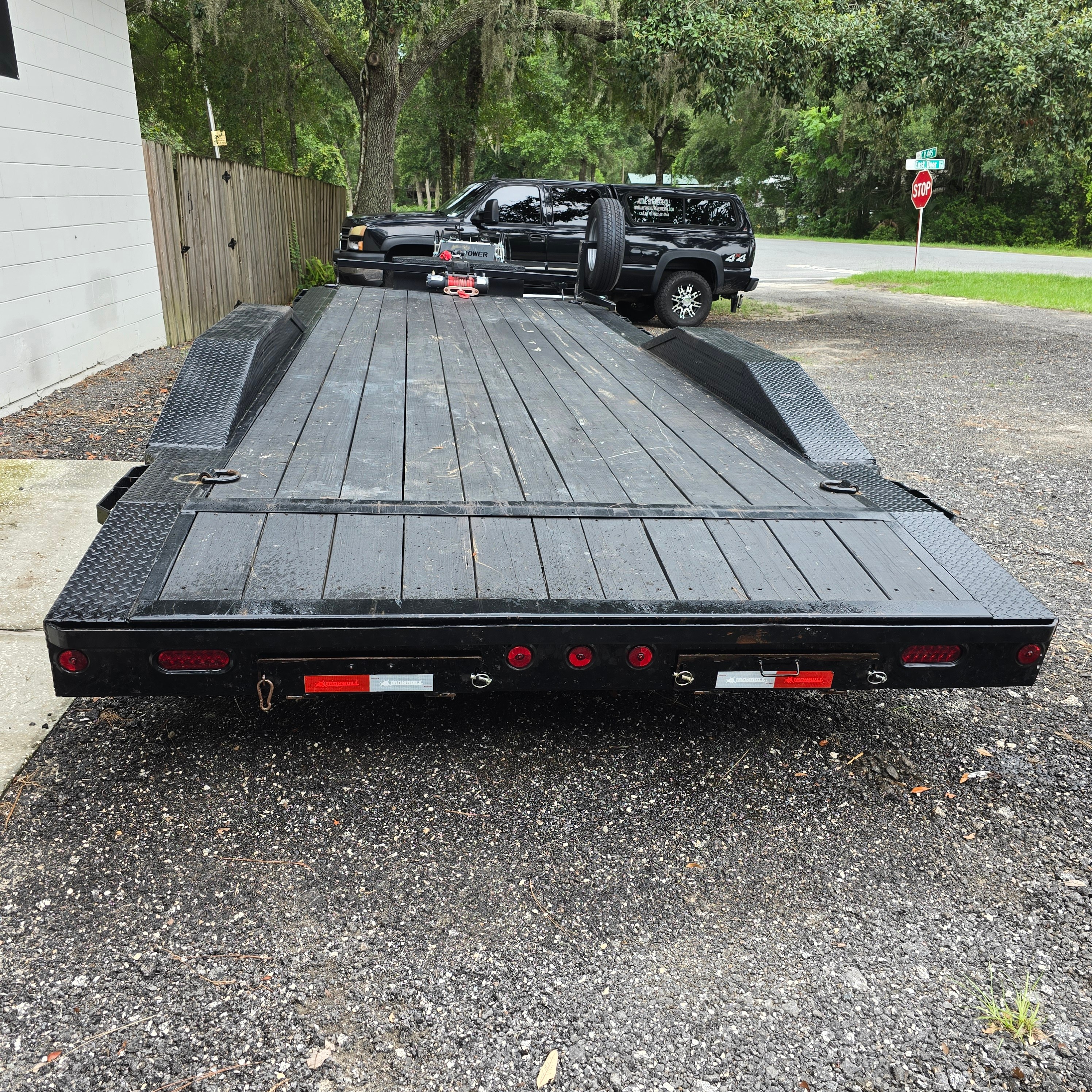 Driver over fender trailer rear view showing wood deck and fold-down fenders in Altoona FL
